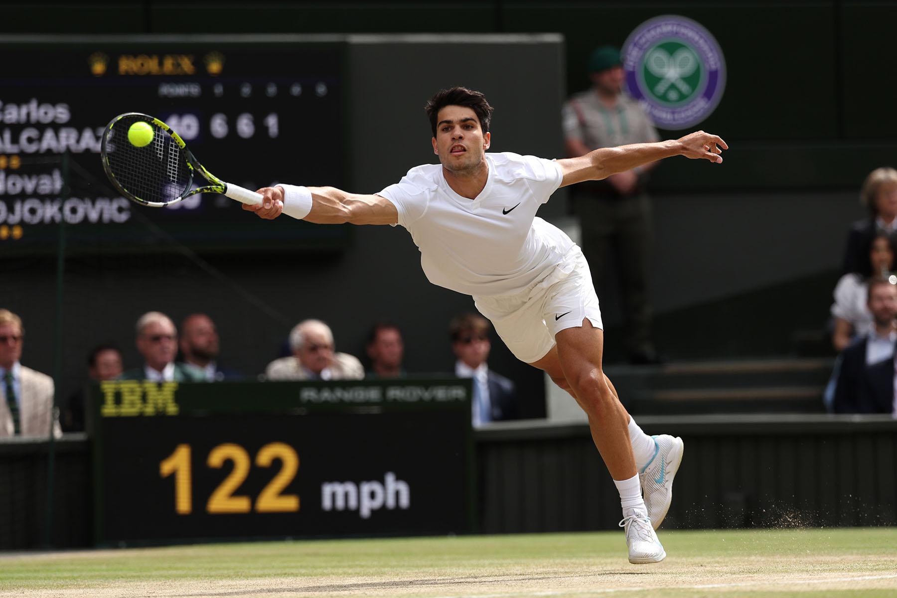 Carlos Alcaraz celebrating at Wimbledon 2024 with his racket